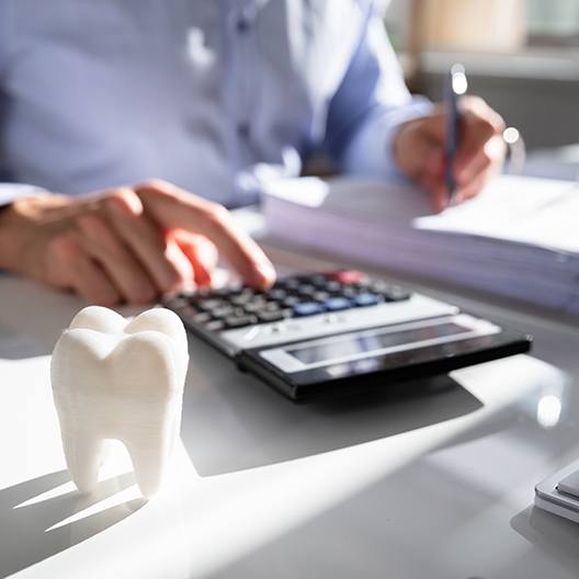 Man calculating the cost of dental treatment