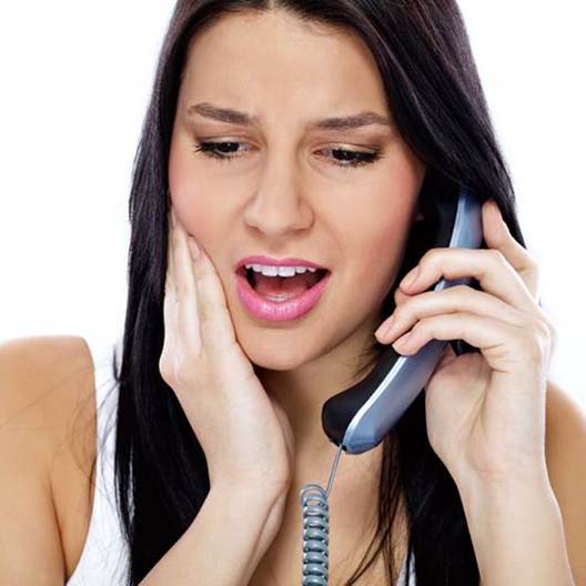 Woman touching her cheek calling Arlington emergency dentist