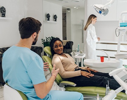 Patient in Arlington talking to dentist about dental implants