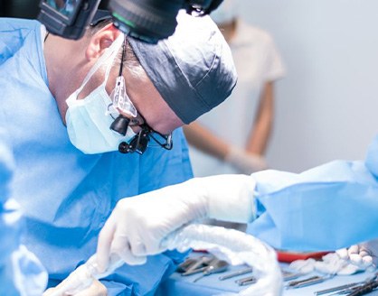 an oral surgeon performing dental implant placement